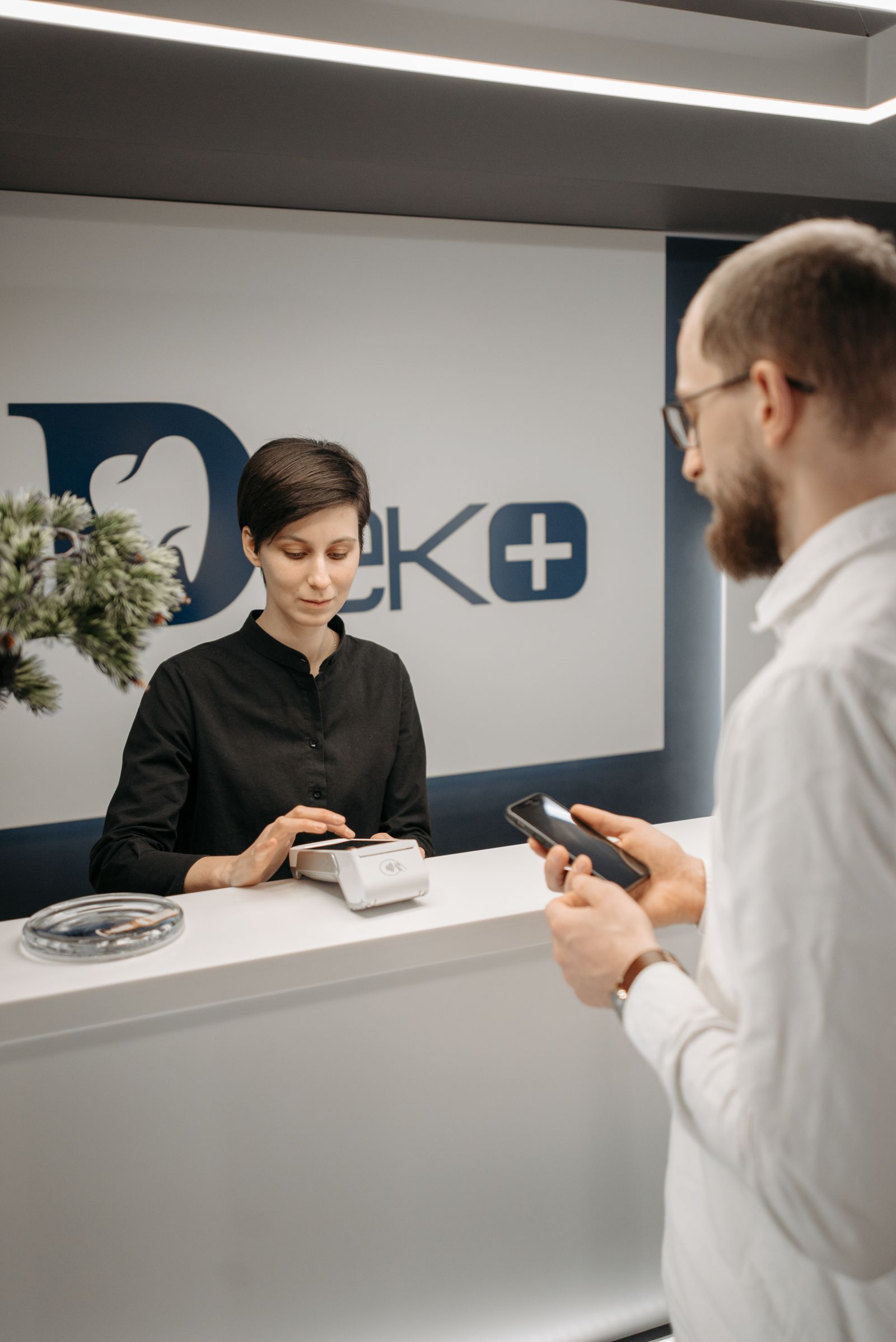 A patient checking in at the front desk